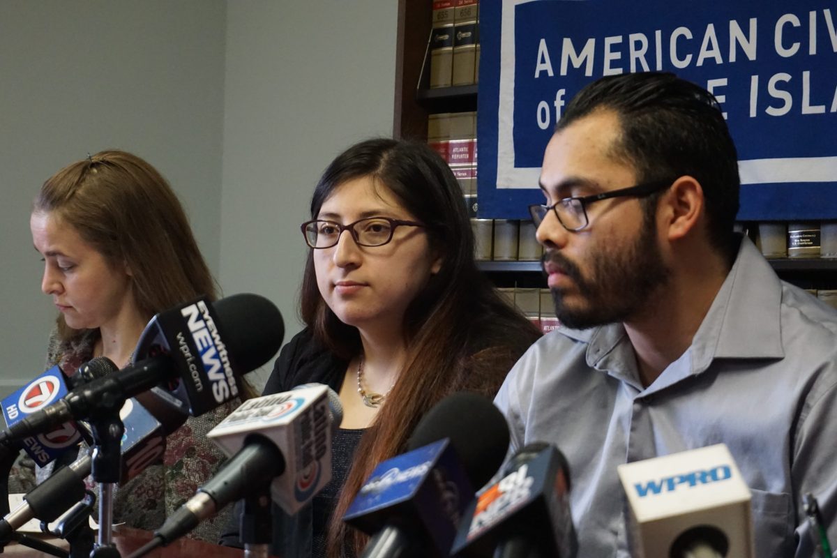 Lilian Calderon (center) sits with her husband Luis Gordillo and ACLU lawyer Adriana Lafaille during a press conference in Providence