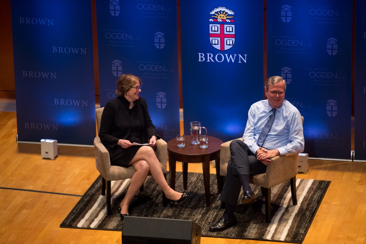 Brown University President Christina Paxson talks with former Florida Governor Jeb Bush