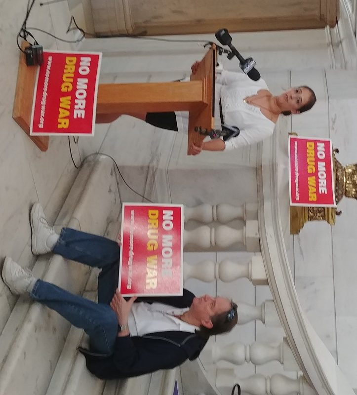 RI Rep. Moira J. Walsh with opponents of Kristen's Law speaks at an "anti-bill signing" event at the State House.