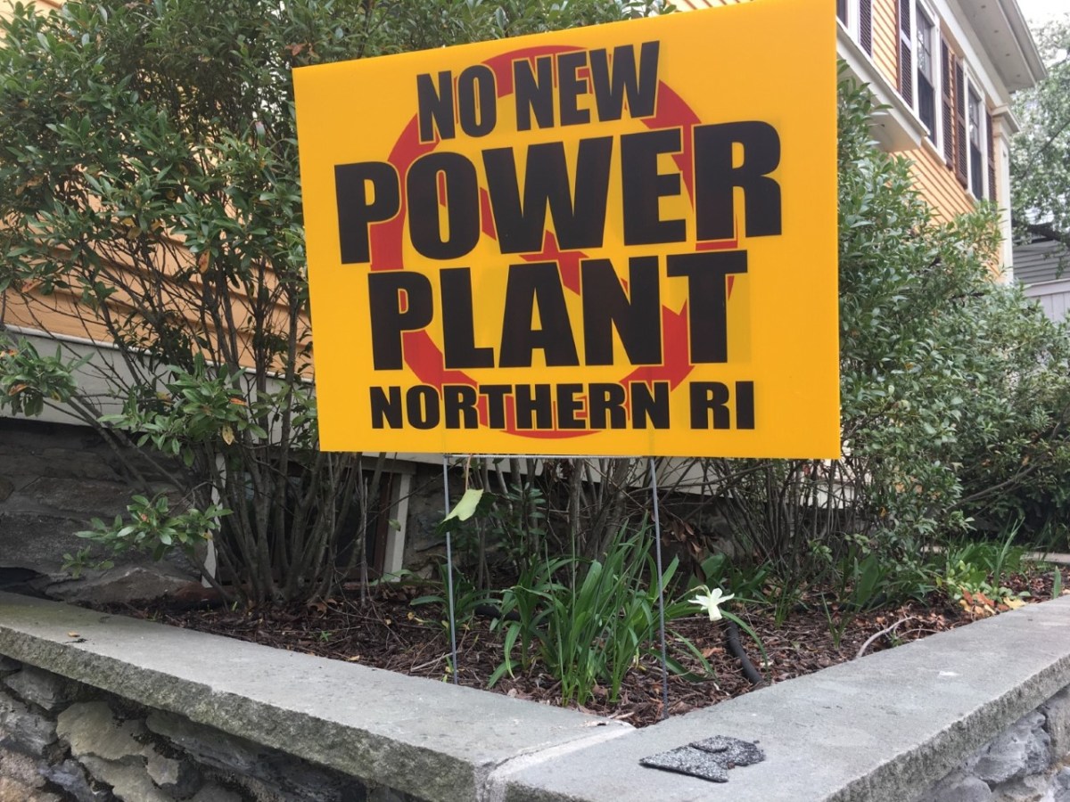 A sign in opposition to a natural-gas power plant proposed in Burrillville sits in the front lawn of a house in Providence.