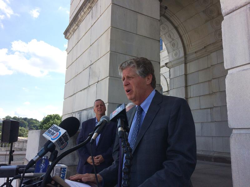 Lt. Gov. Dan Mckee stands in front of the RI Statehouse, flanked by mayors. Pawtucket Mayor Don Grebien stands behind him.