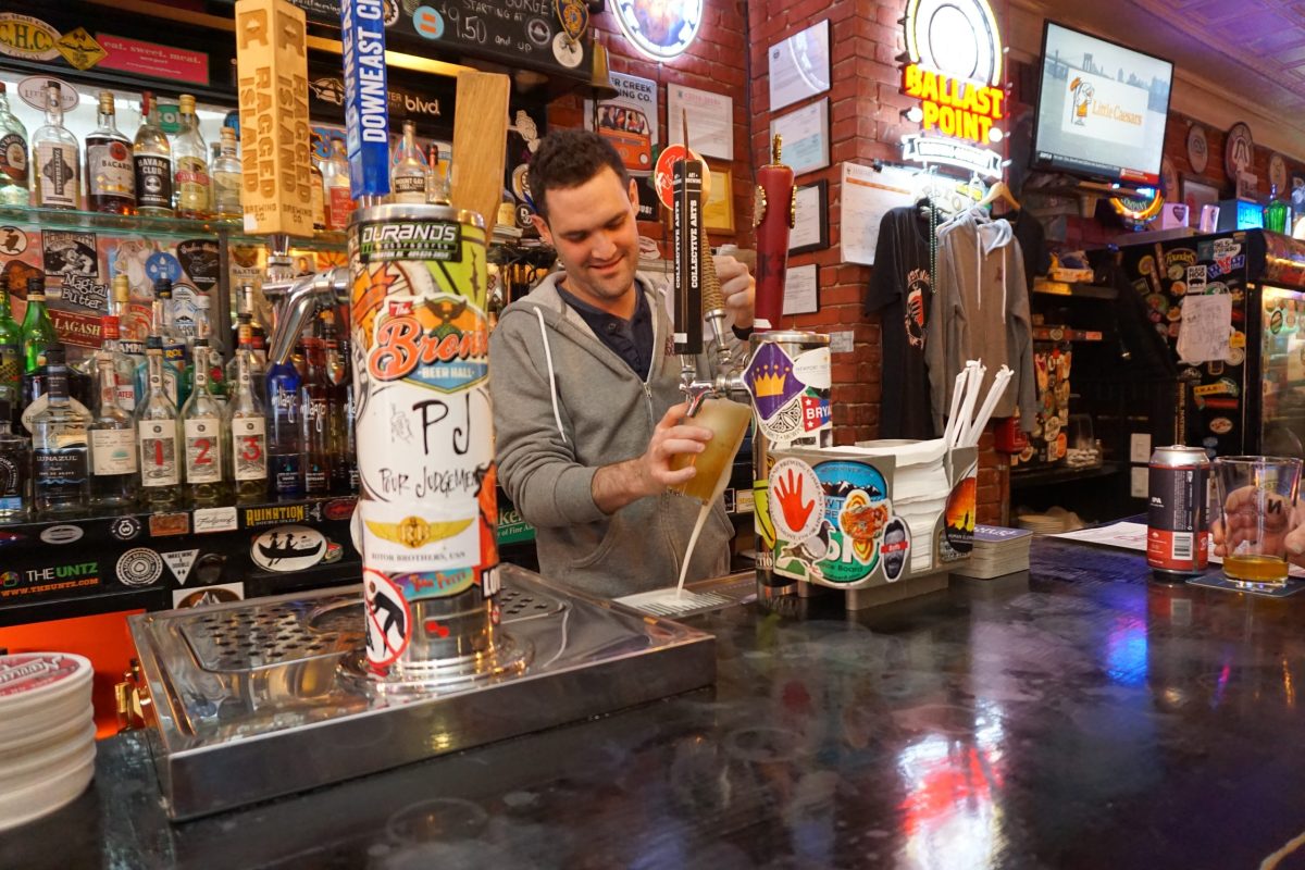 Ethan Leary pours a beer at Pour Judgement in Newport.