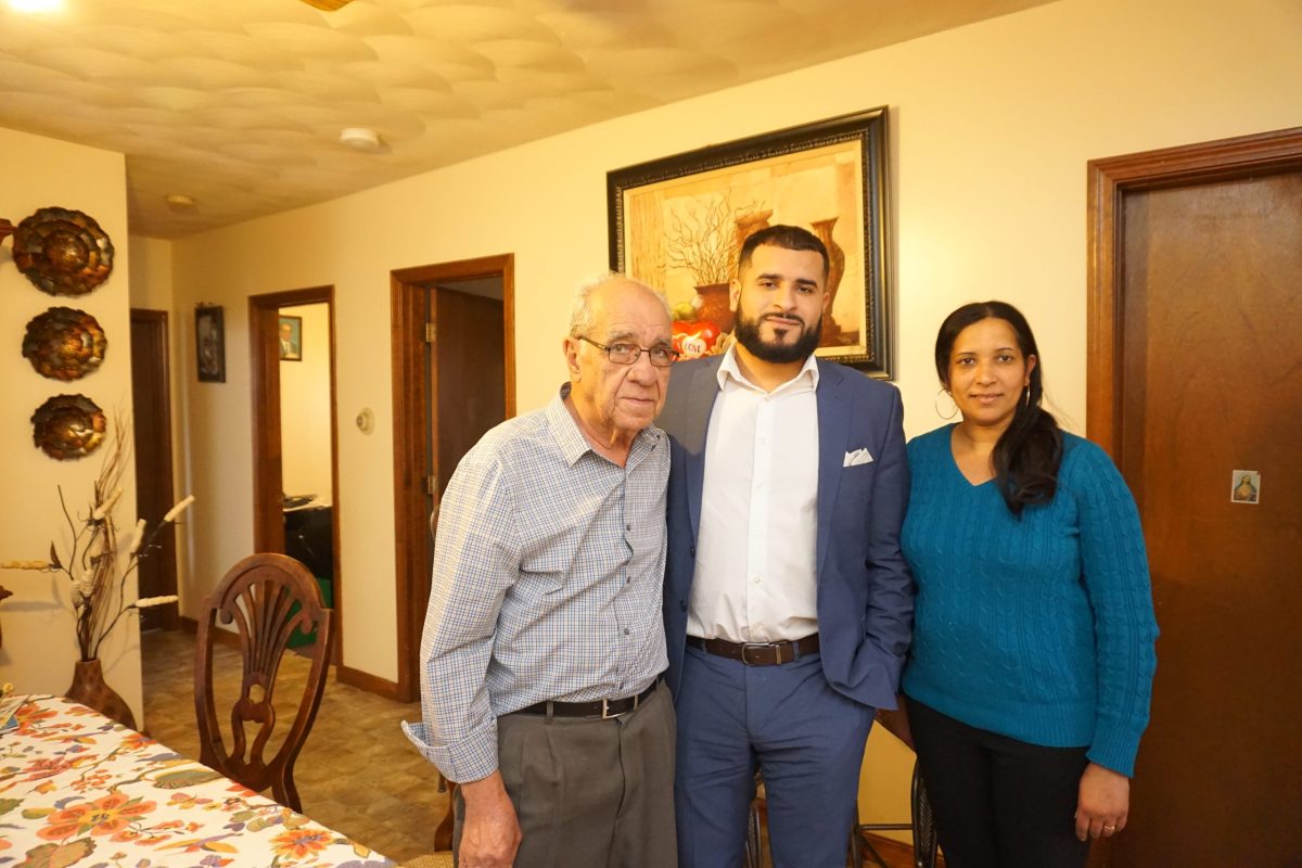 Lucidio, Belmiro, and Augusta Bala, standing in the Bala's Pawtucket dining room