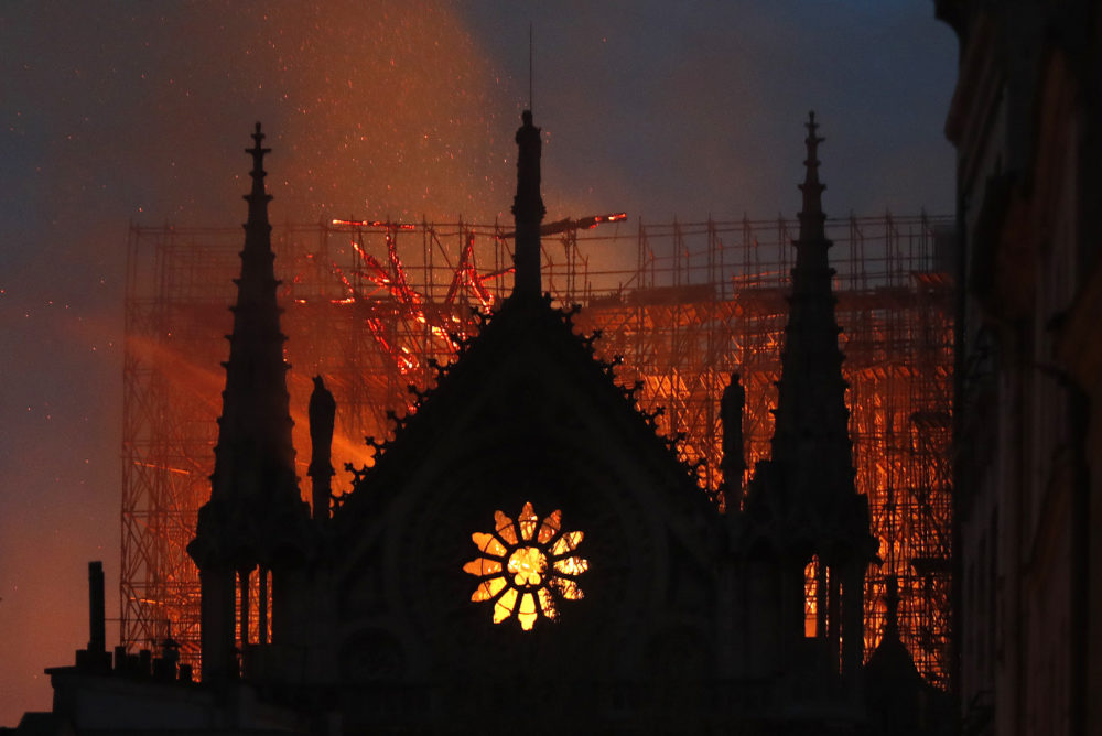 Flames and smoke rise from Notre Dame cathedral as it burns in Paris, Monday, April 15, 2019.