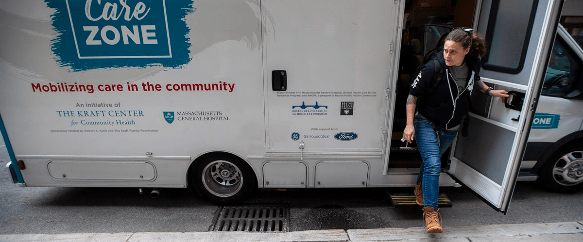 Sarah Mackin exits the Care Zone van after it parks on Haverhill Street near North Station. The outreach workers will mobilize and walk around the area to look for opioid users who need assistance.