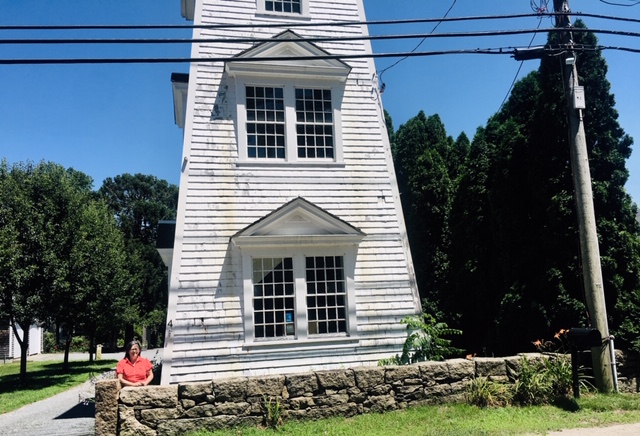 Kitty Lovell in front her water tower studio in Adamsville, RI