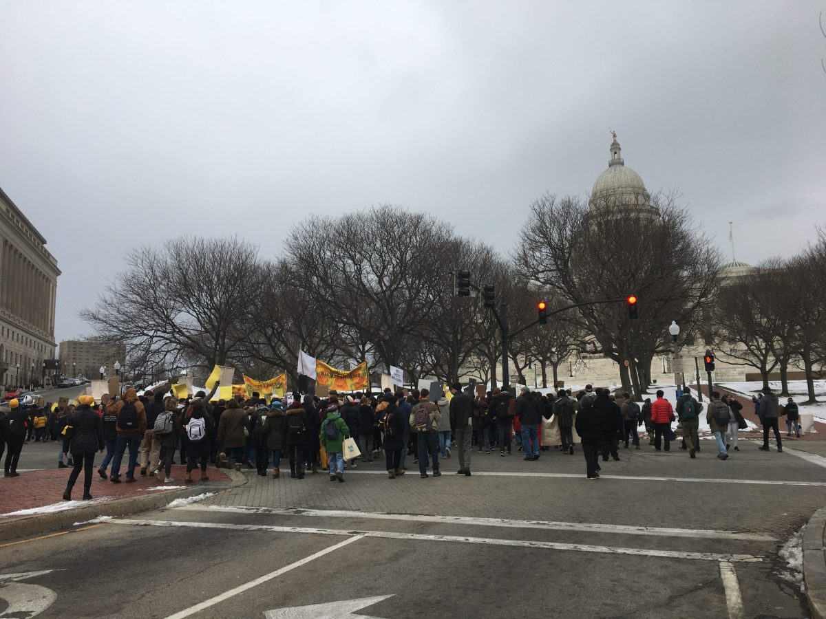 Protesters with the Sunrise Movement march towards the Rhode Island Statehouse