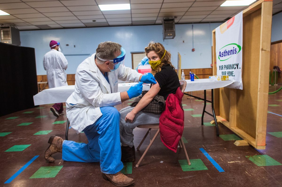 Bea Mandel, 23, receives a COVID-19 shot at the Knights of Columbus Hall in Central Falls in January.