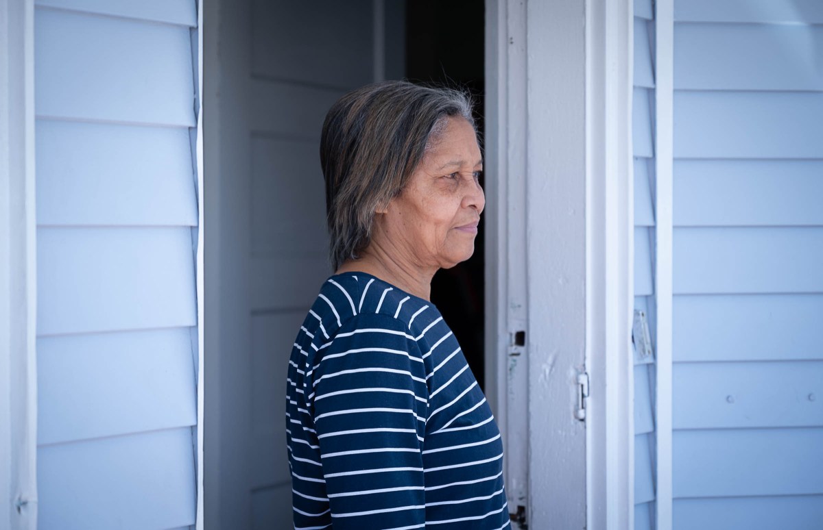 Gertrudis Pena outside her home in Providence