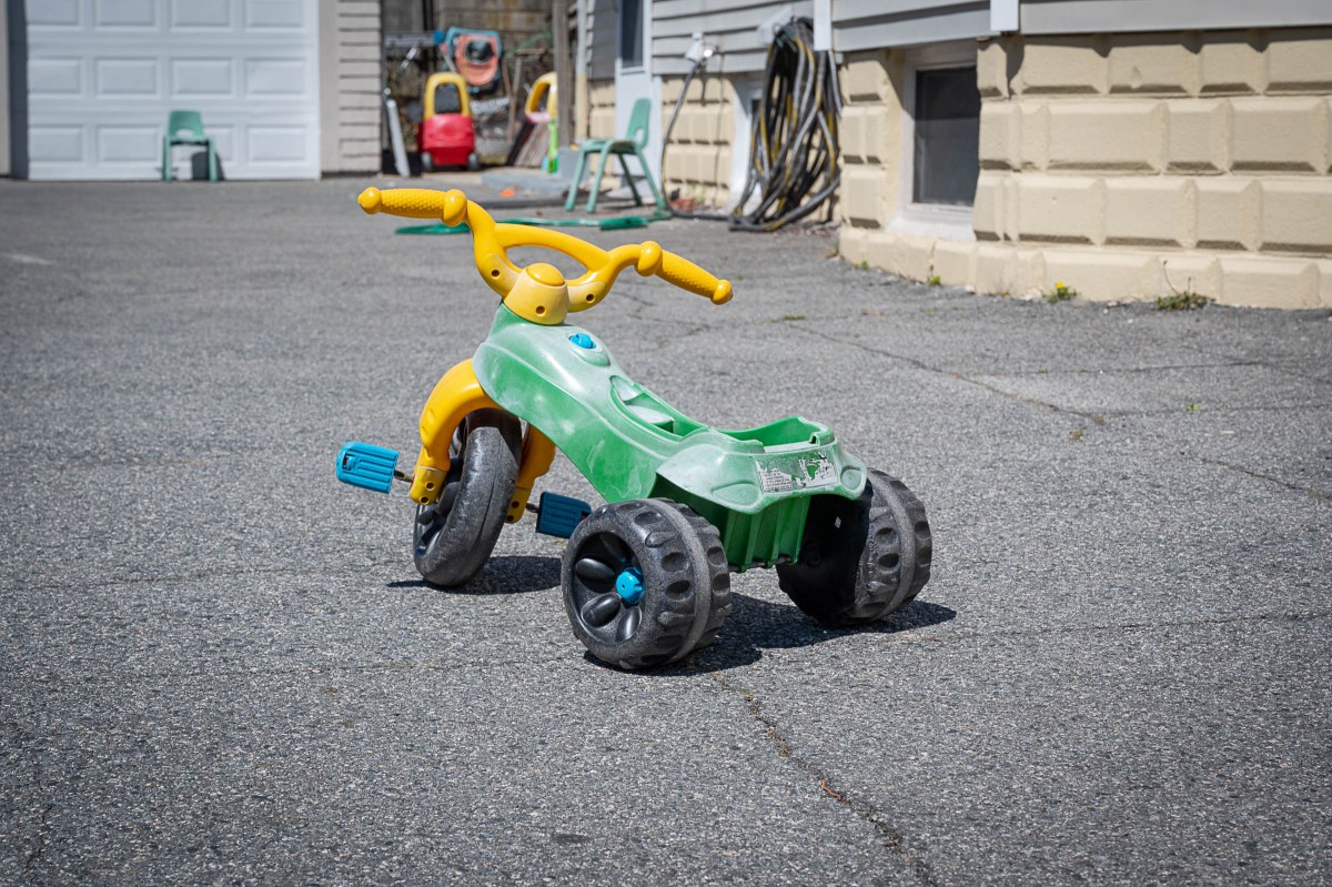 A tricycle sits outside a home-based child care in Providence.