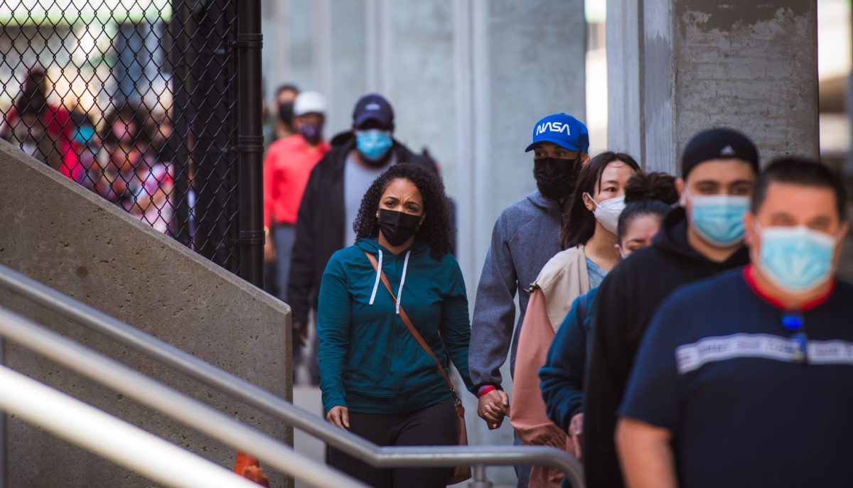 People arrive at the Dunkin' Donuts Center in Providence on Saturday for a COVID-19 vaccination clinic for residents of color.