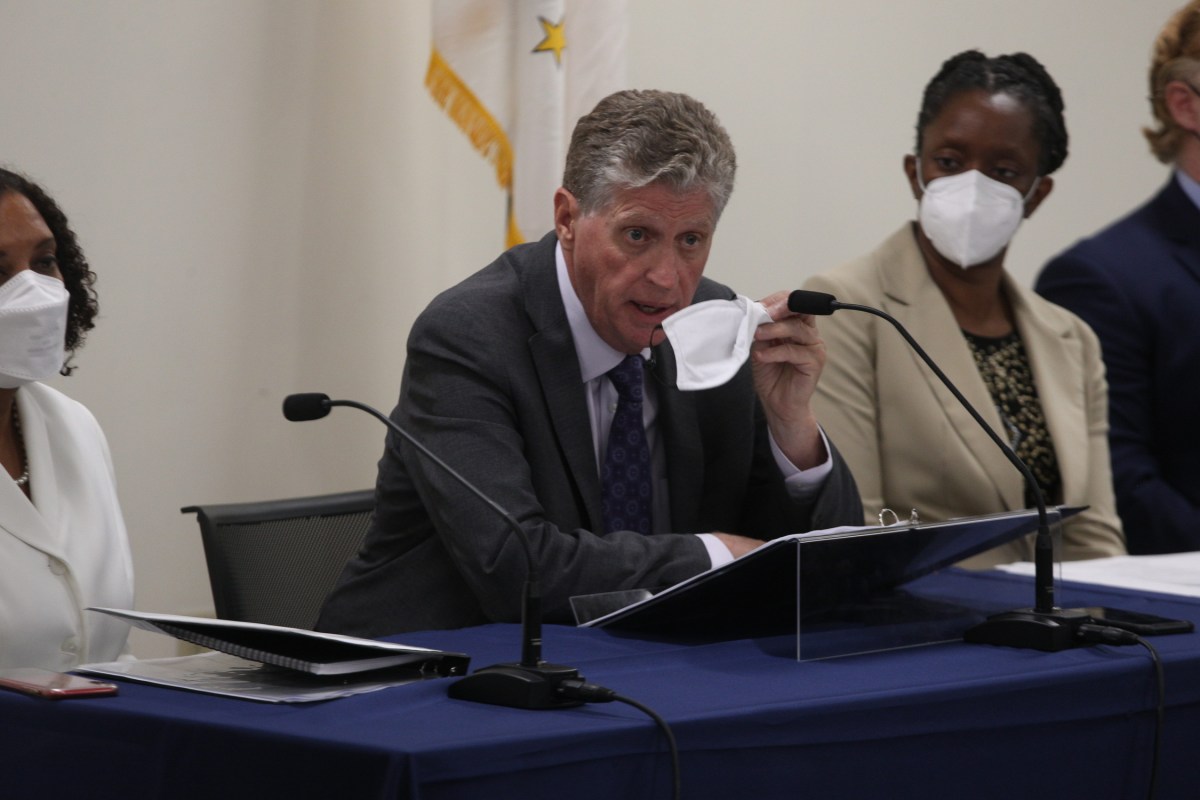 Gov. Dan McKee speaking at a news conference with Health Director Dr. Nicole Alexander-Scott (right) Aug. 1 2021