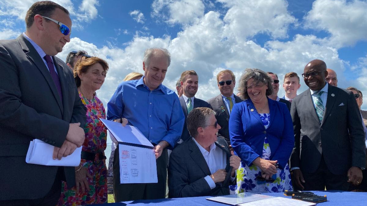 Gov. McKee signing wind energy legislation on Wednesday, July 6, 2022