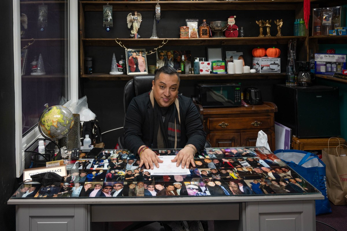 Chiqui Versace at his desk, in a space he shares with his sister in Central Falls.
