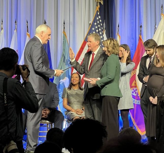 McKee being administered the oath of office by Attorney General Peter Neronha