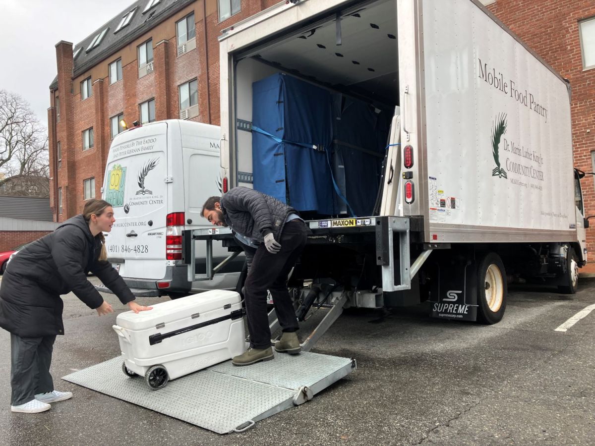 Mia Ceglie and Emilio Ruiz load perishable into the MLK Center's mobile pantry truck.