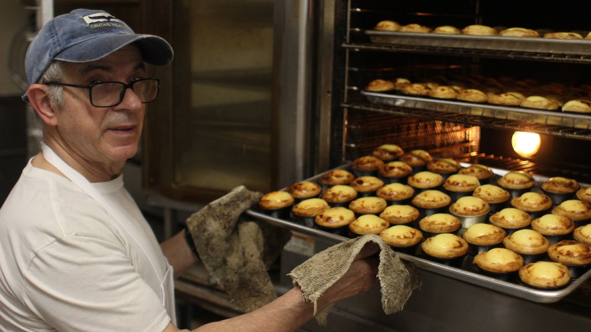 Abel Afonso pulls his top-rated pasteis de nata from the oven at Goulart Square Bakery in New Bedford.