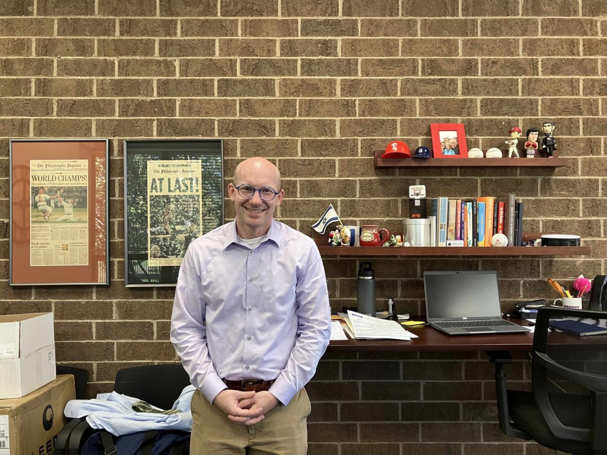 Adam Greenman, president and CEO of the Jewish Alliance of Greater Rhode Island, poses for a portrait in his office on the east side of Providence on Thursday, Oct. 12, 2023. Greenman is a devoted Phillies fan.
