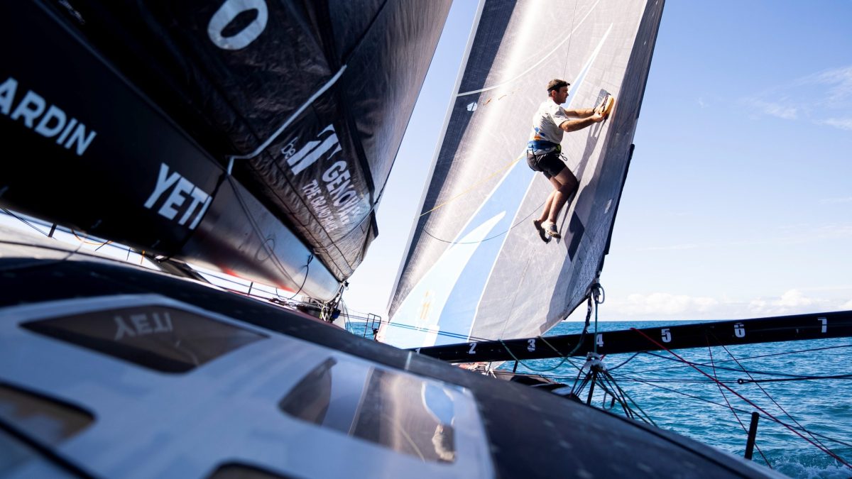 Skipper Charlie Enright fixes a small tear in the J2 while it's high and dry during Leg 4 of The Ocean Race on Wednesday, April 26, 2023.