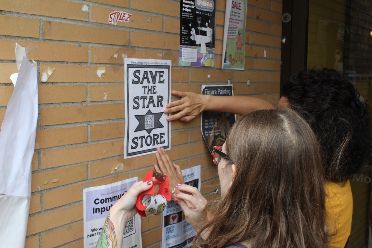 UMass-Dartmouth students post flyers in downtown New Bedford linking to a petition to keep the art department at the Star Store