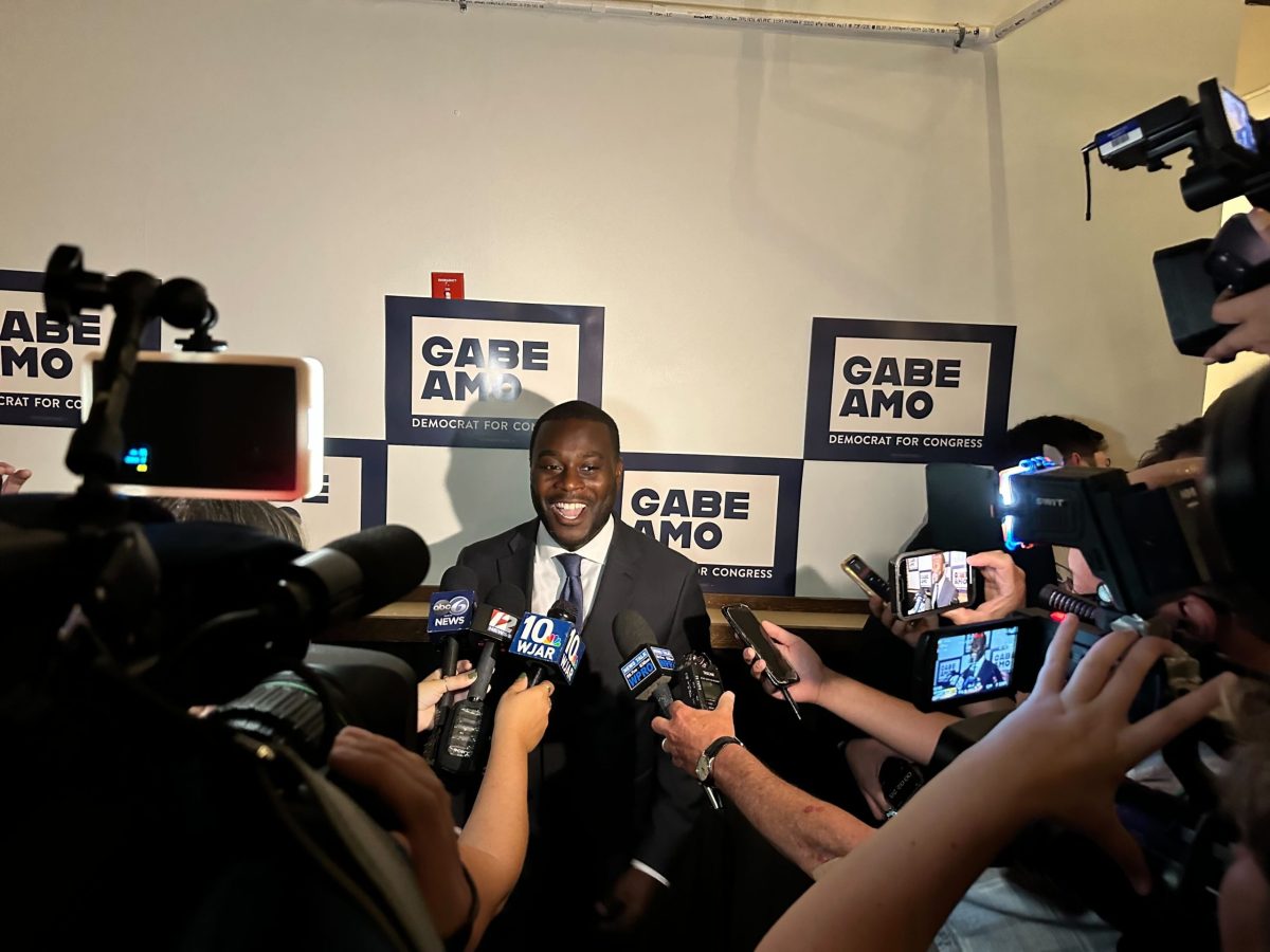 Gabe Amo smiles for the press after winning the Democratic special election primary.