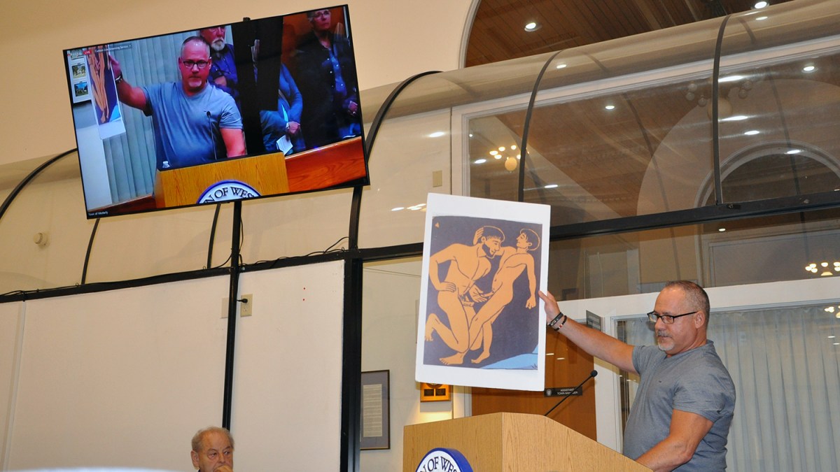 Westerly resident and supporter of House Bill 6324 Robert Chiaradio holds up a poster size display of an image from the book “Gender Queer: a Memoir” he says should not be loaned to children from school libraries in Rhode Island.