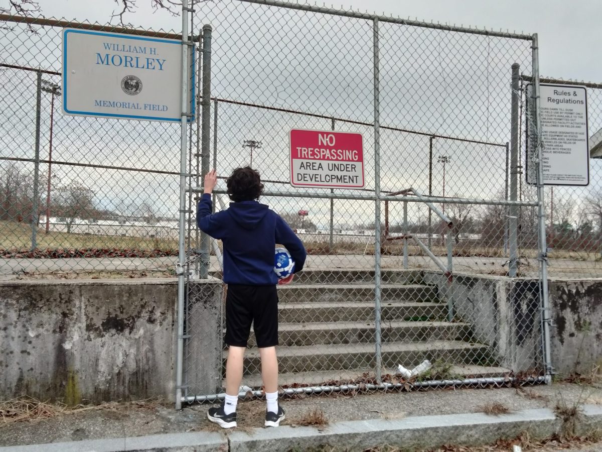 Pawtucket resident Tristan Gregor stands outside of the locked gates of Morley Field.
