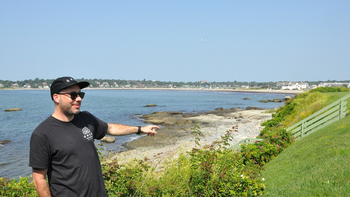 Cheyne Cousens points to the stairwell he attempted to use to access the shore in Middletown. A property owner claims it’s not for public use.