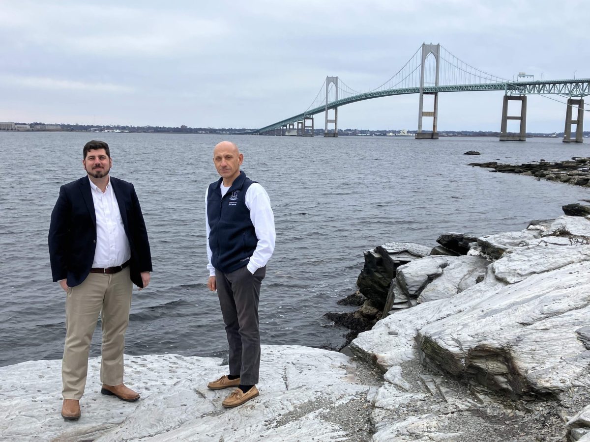 Representative Joseph Solomon, Jr., left, and Senator Louis DiPalma pose for a portrait at Taylor Point in Jamestown, RI, with the Newport Pell Bridge in the background, on Saturday, January 6, 2024. The two RI legislators have sponsored legislation that they intend will one day fund suicide prevention barriers on the four bridges in Newport County.
