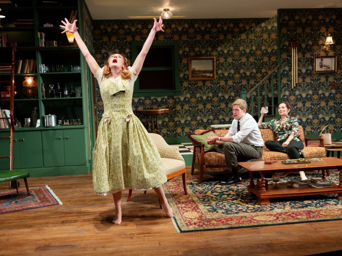 Left to right: Gabrielle McCauley (who plays Honey) throws her hands up in the air while Gunnar Manchester (who plays Nick) and Jeanine Kane (who plays Martha) observe from the couch.