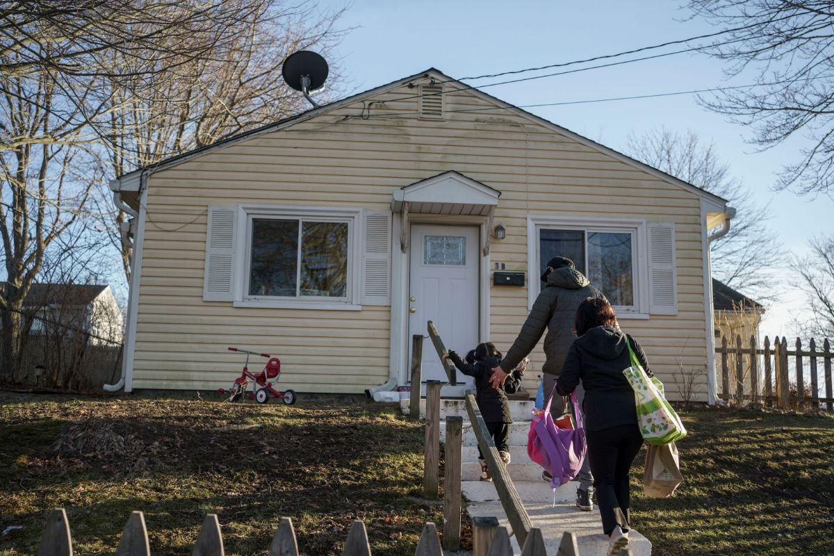 Edson Pereira and Suany Ortiz walk into their new home. While living in a previous apartment, a test showed their daughter had been lead poisoned.