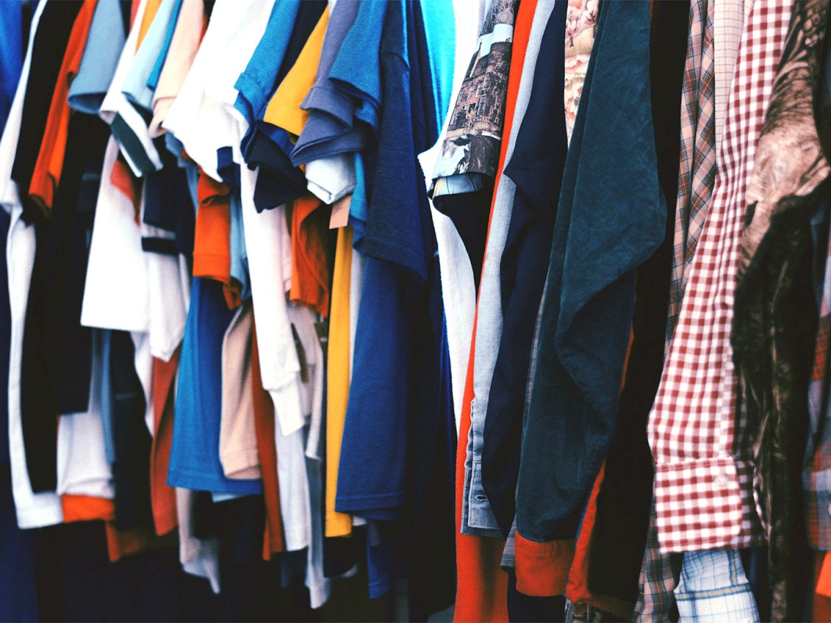 T-shirts and button down shirts on a rack.