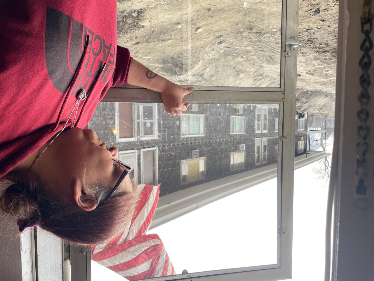 Melissa Potter looks out over the 6-foot-deep trench directly outside her front door. 