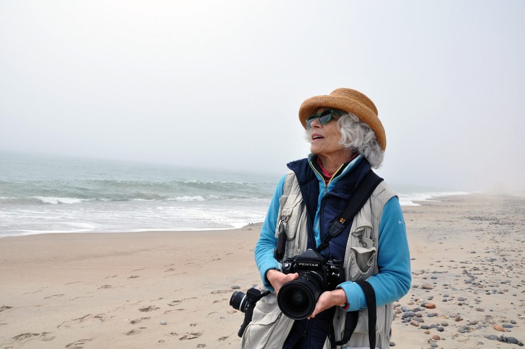 Photographer Kathie Florsheim on the beach at Roy Carpenter’s Beach in South Kingstown.