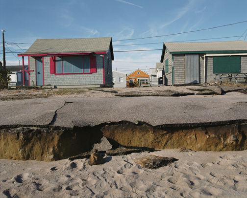 A photograph captures damage to shoreline homes at Roy Carpenter’s Beach in South Kingstown.