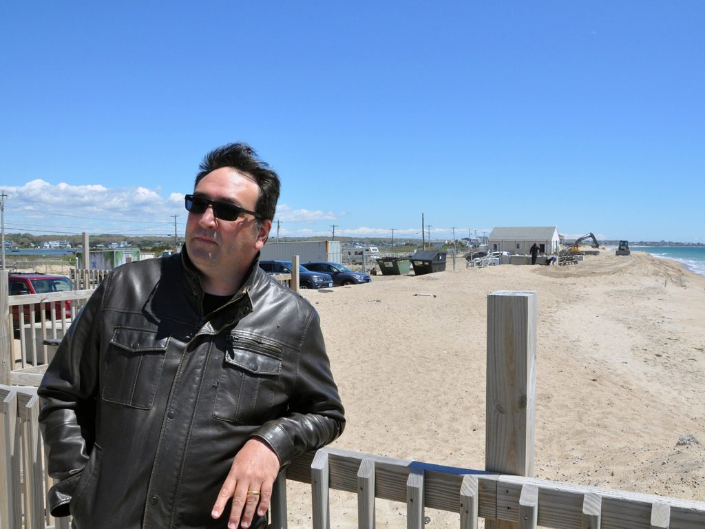 Misquamicut Business Association Executive Director Caswell Cooke stands outside the Windjammer Surf Bar on May 13, 2024. Cooke is proposing a beach nourishment project to dredge sand from the ocean floor and pump it onto the beach along the Misquamicut barrier beach.