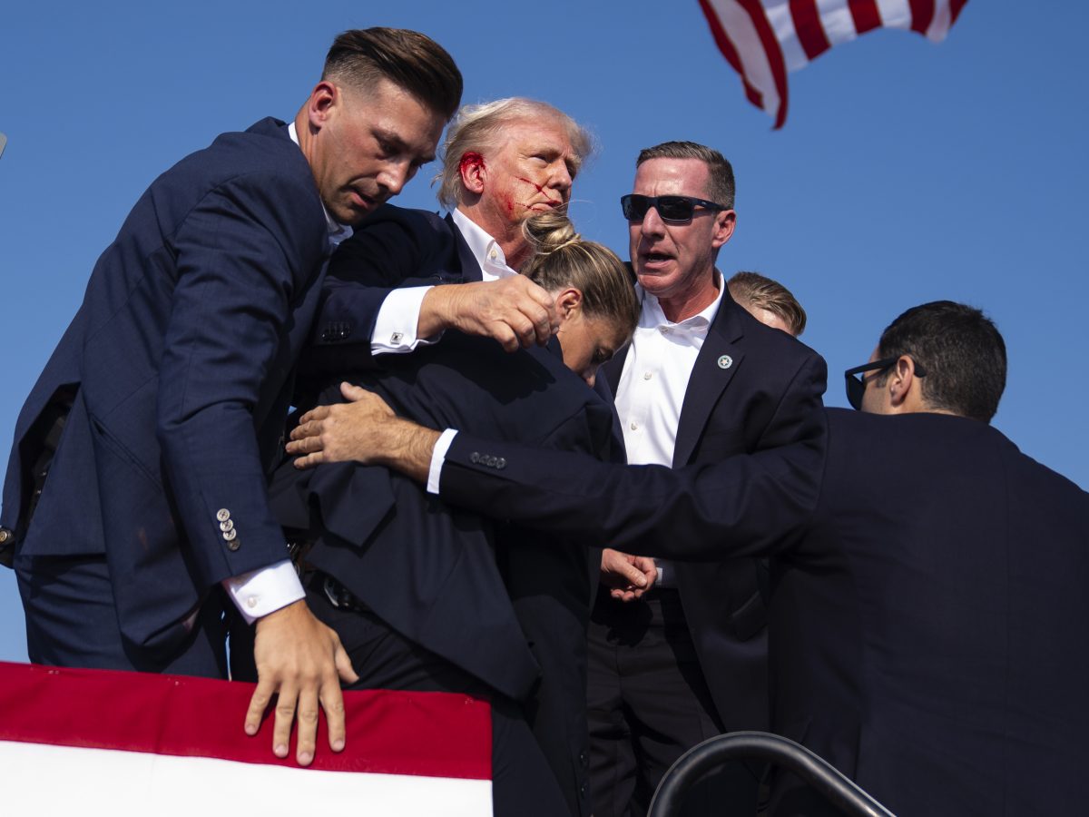 Republican presidential candidate former President Donald Trump is surrounded by U.S. Secret Service agents at a campaign rally, Saturday, July 13, 2024, in Butler, Pa.