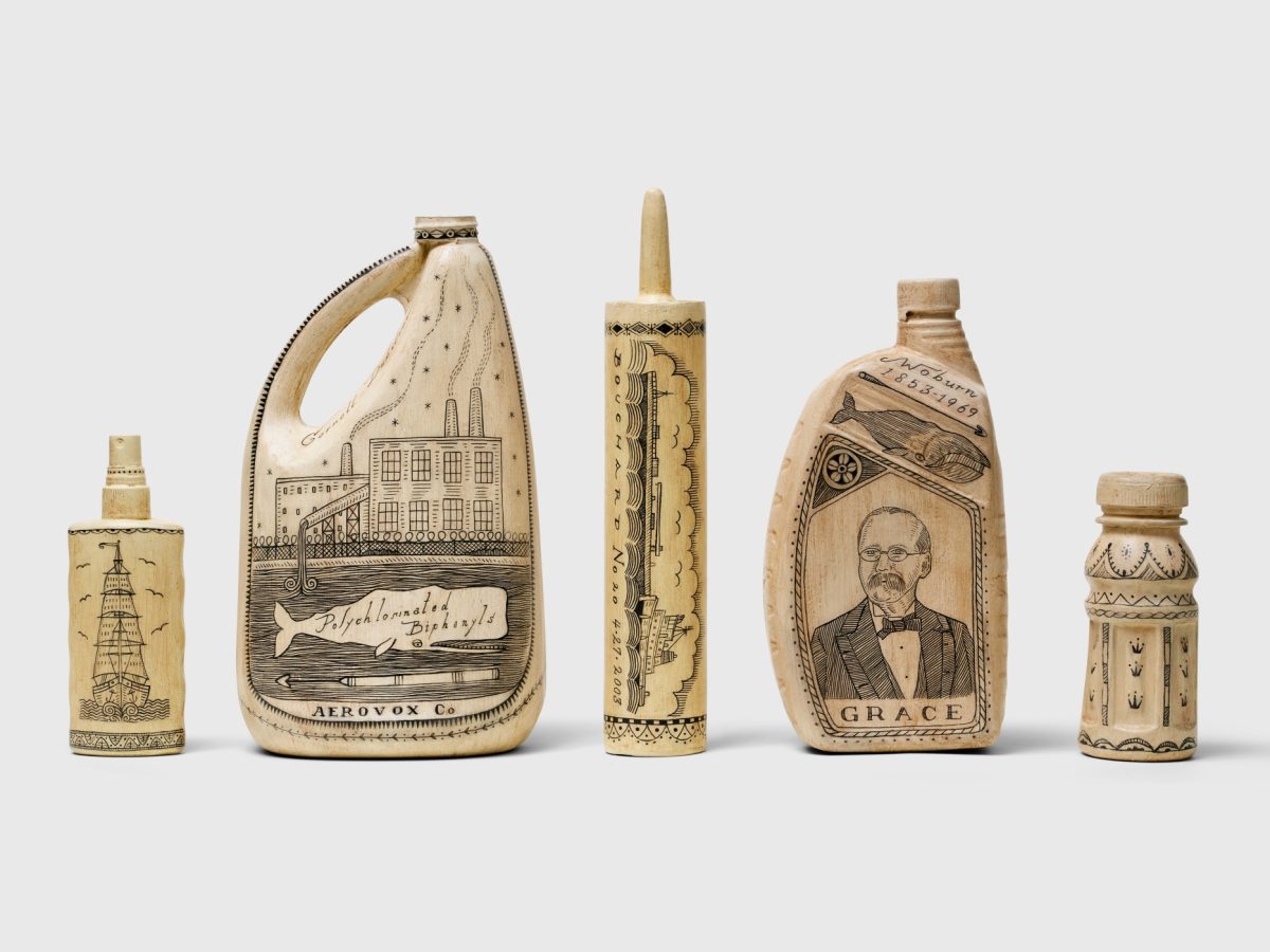 Five pieces of plastic scrimshaw by Duke Riley on display.